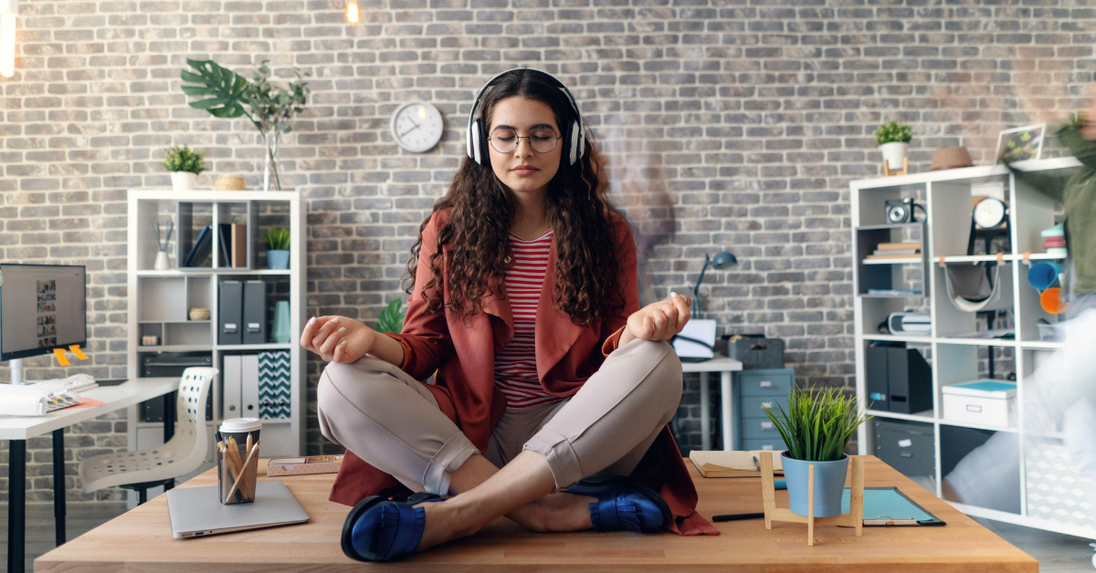 Founder practicing mindfulness and identity-based habits in a modern office setting, symbolizing focus, clarity, and personal transformation for entrepreneurial success.